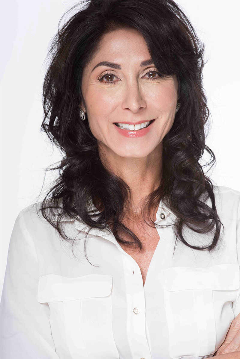 A woman with long black hair wearing white shirt.